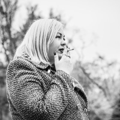 Black-and-white photograph of woman smoking.